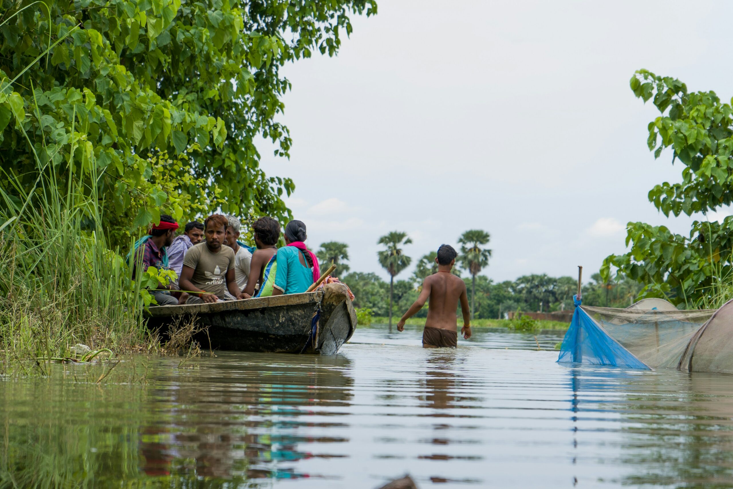 Children on a boat in a flooded area